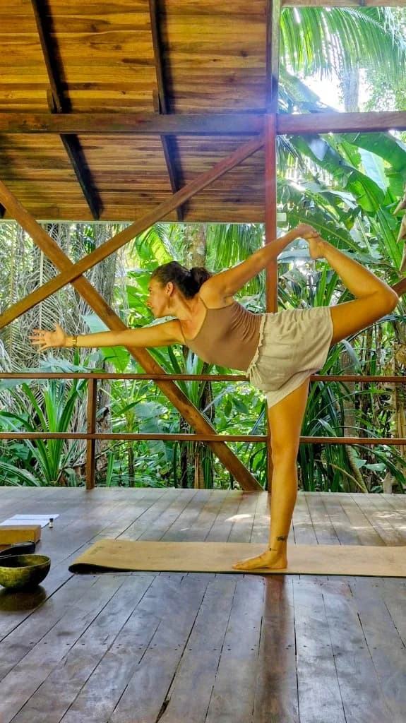 Marine in Natarajasana on the terrace open to the forest